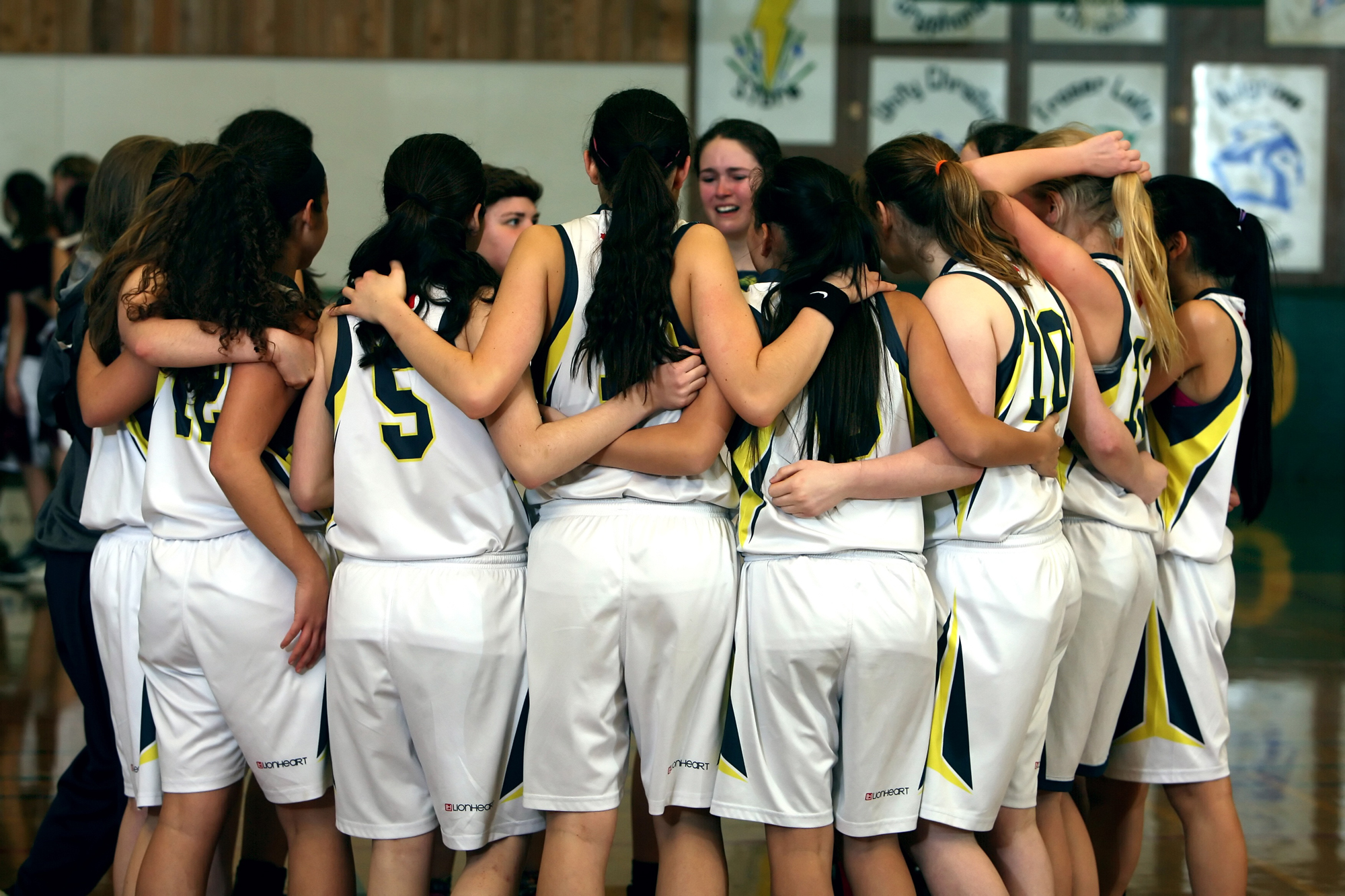 Girls Basketball Team giving each other moral support