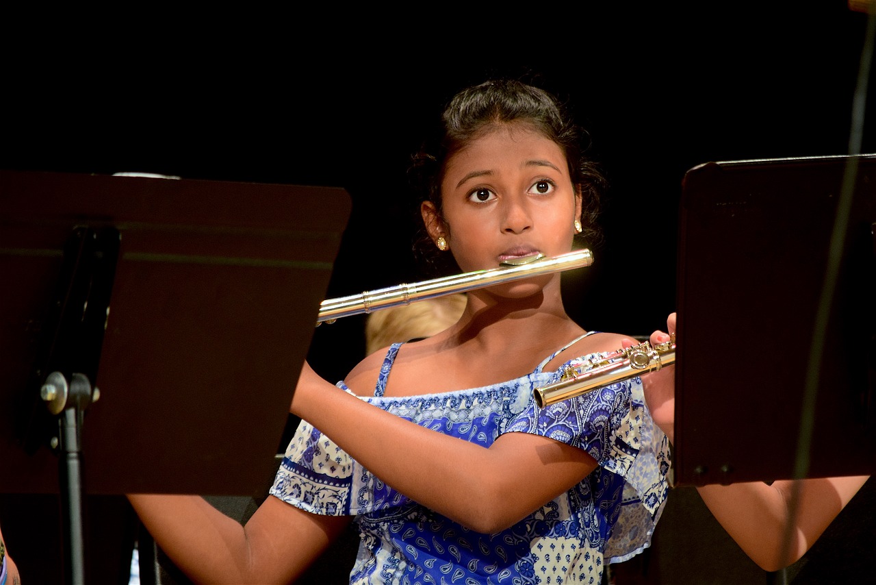 Student playing flute in orchestra