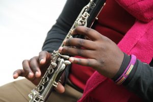 Student Playing Instrument in orchestra