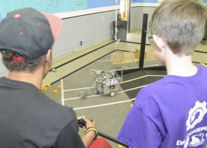 Odyssey of the Mind Team using its Robot