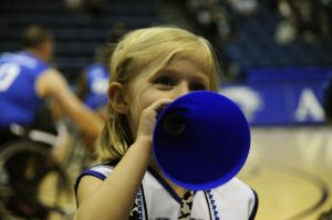 Little kid showing support for their booster club's team