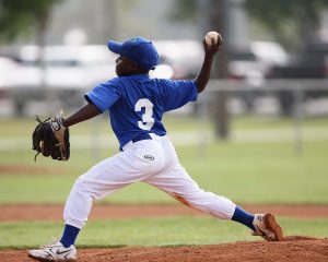 Baseball pitcher throwing pitch in game