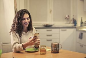 Volunteer setting up a booster club crowdfunding campaign on their mobile phone