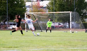 Soccer players in game supported by the soccer booster club