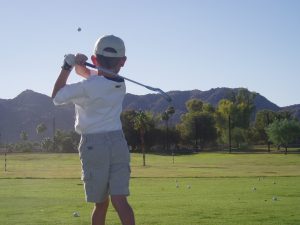 Junior golf player learning to play