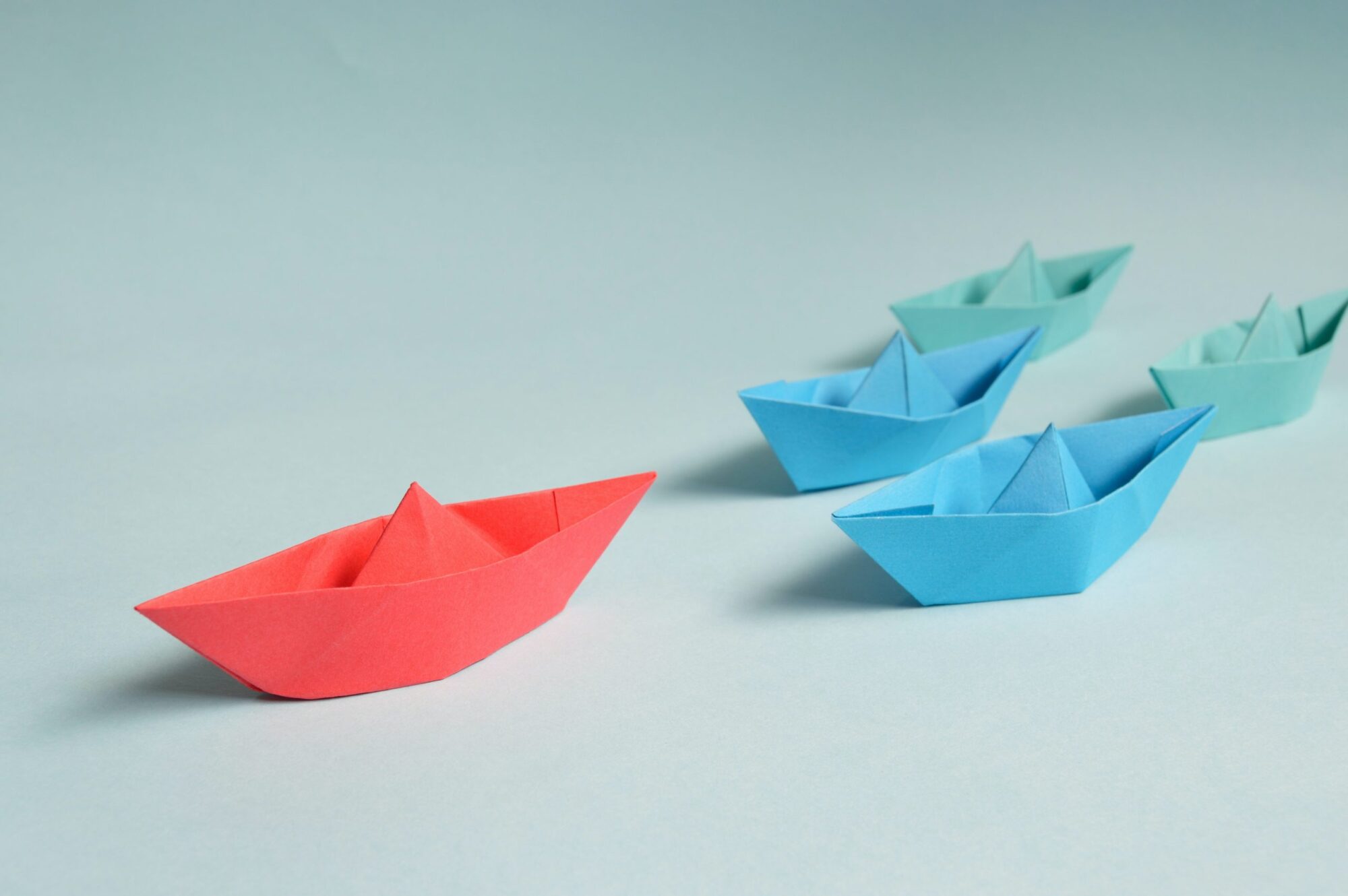 Paper boats showing leadership concept