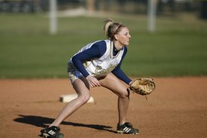 Softball infielder in ready pose during game