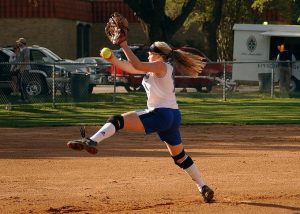 Softball pitcher in middle of wind-up