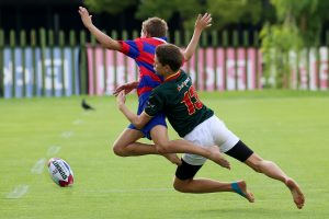 Tackle in progress during a rugby match.