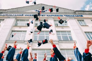 Graduates tossing their caps in the air.