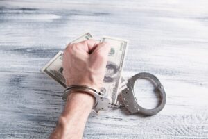 Booster club pay to play scheme can lead to handcuffs and criminal charges.