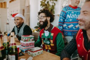 People attending a holiday themed ugly sweater party fundraiser