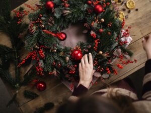 Woman building a wreath for a booster club holiday fundraiser.