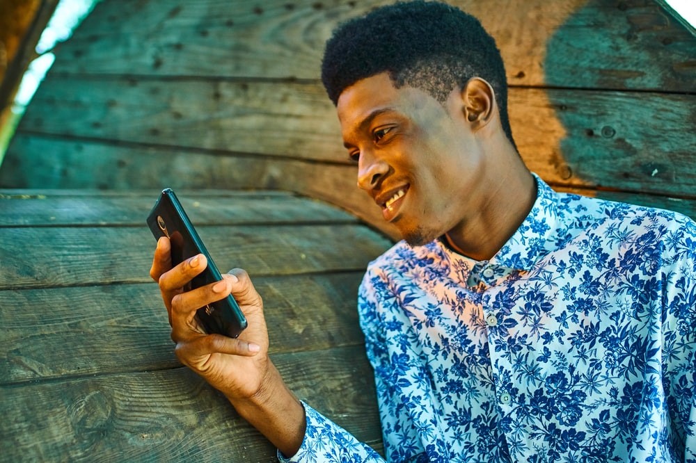 A booster club supporter checking his text message from a booster club.